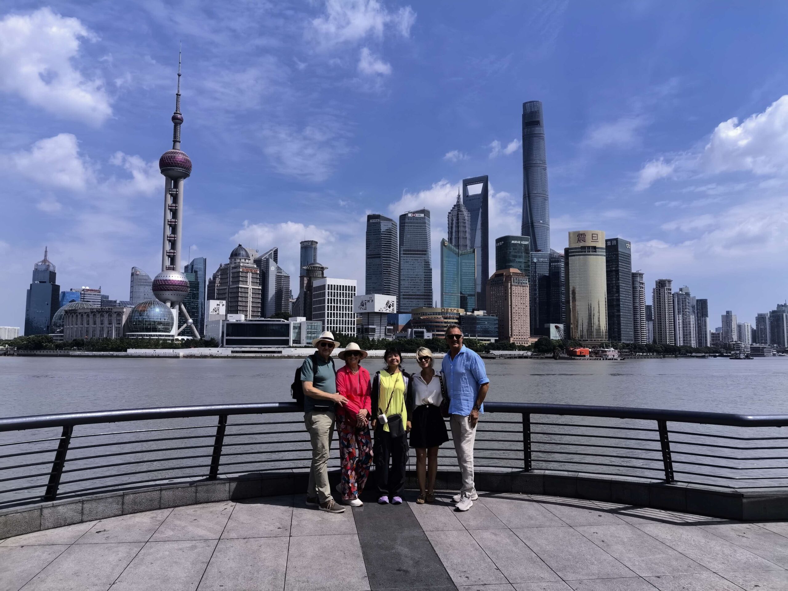 Guests on a Shanghai Layover Tour at the Bund with the Pudong skyline behind them
